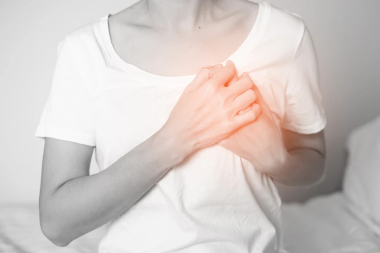 Woman holding chest