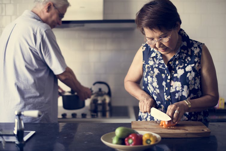 Old couple preparing food