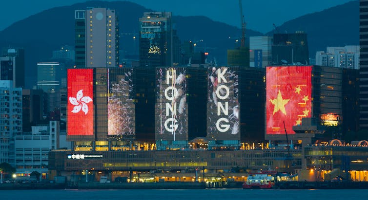 Red flags and the words Hong Kong on banners.
