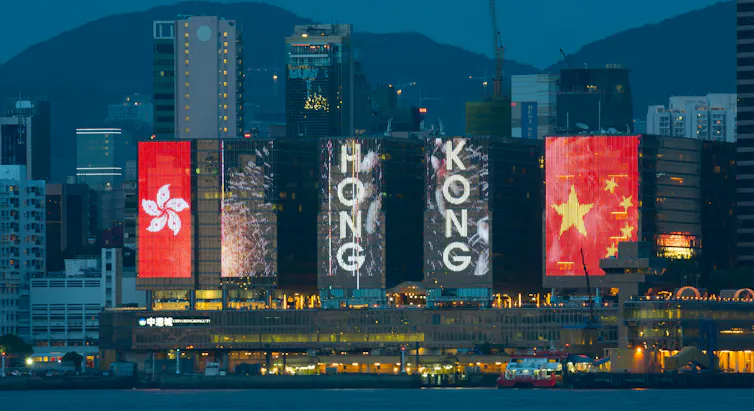 Red flags and the words Hong Kong on banners.