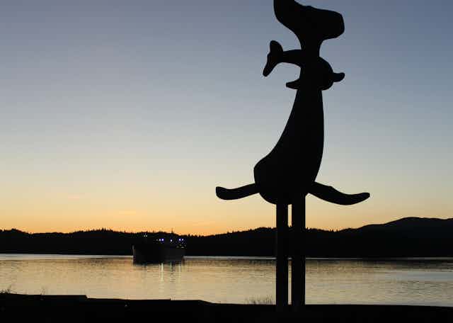 A whale statue at sunset