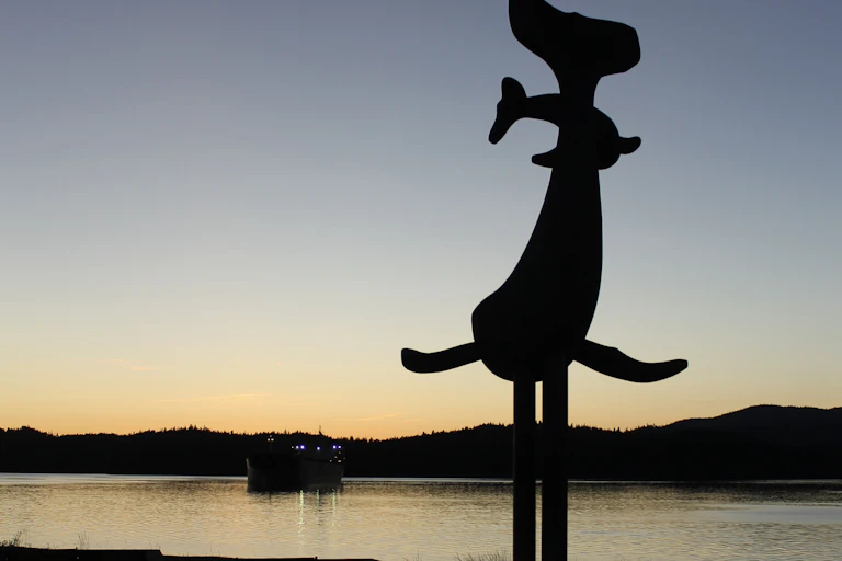 A whale statue at sunset