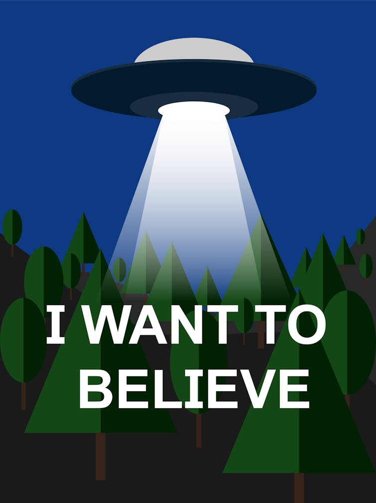 A blue and green poster shows a UFO above a forest and the words 'I want to believe.'