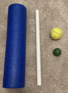 a foam roller, a PVC pipe and two balls