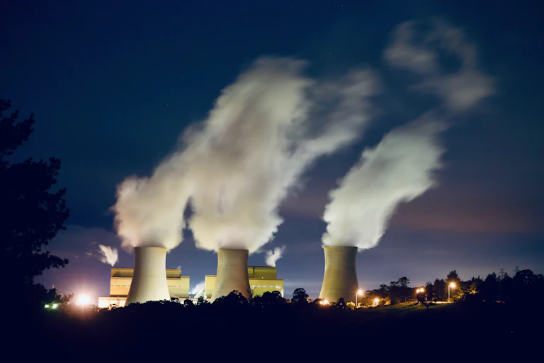 steam billows from coal plant chimneys