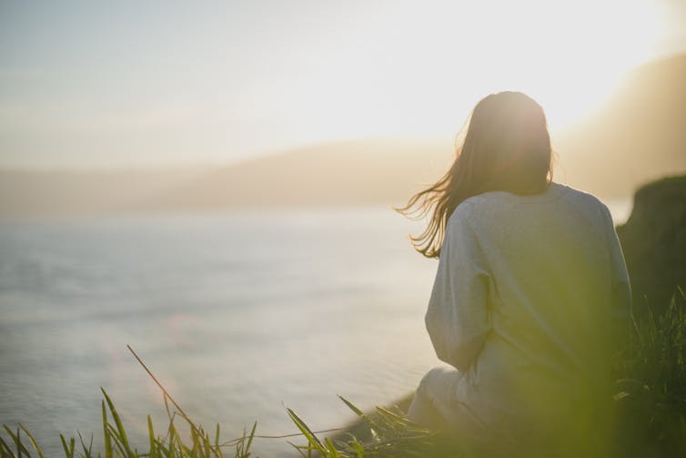 Woman looking off into sunset