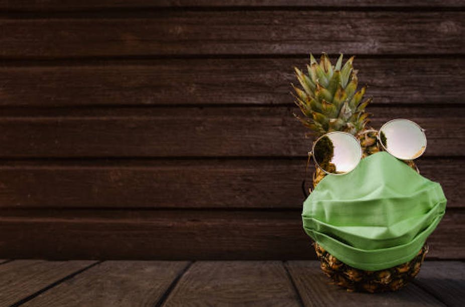 Pineapple with pineapple-fibre mask and sunglasses