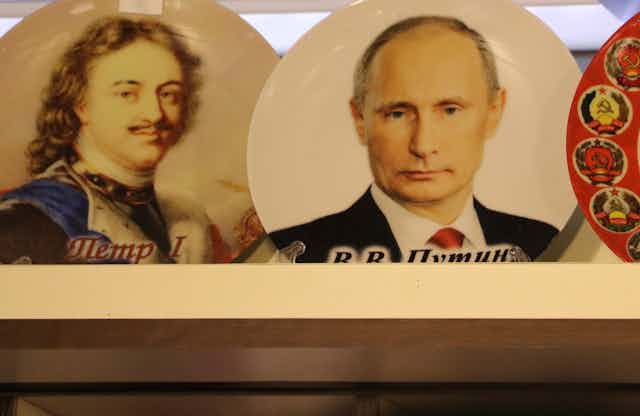 Souvenir plates showing Peter the Great, Vladimir Putin and the Soviet Union