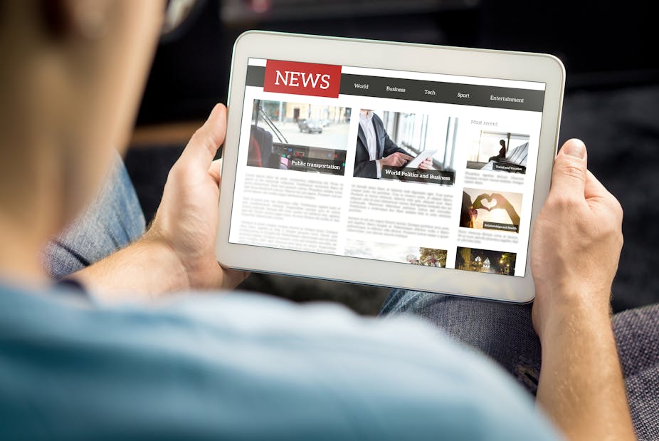 Person reading news headlines on a tablet