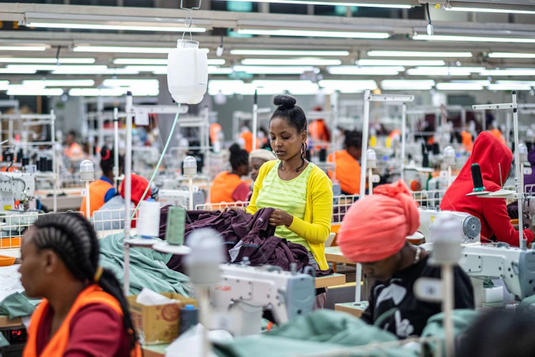 Women using sewing machines at a garment factory.