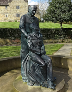 A statue of a surgeon with a burns patient.