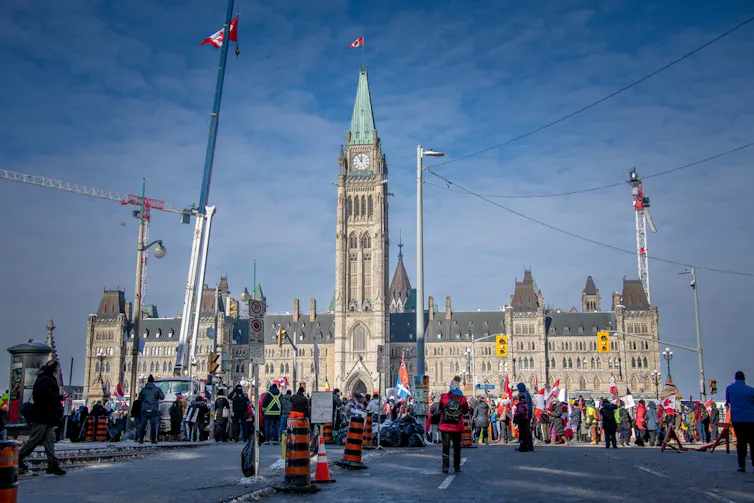 a crowd starts building up in front of a government building