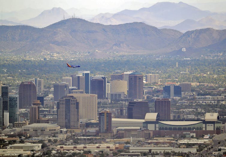 A view of the city of Phoenix, Arizona, with sparce tree cover