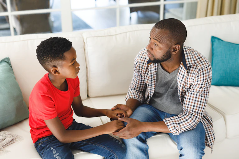 Father and son sat down holding hands
