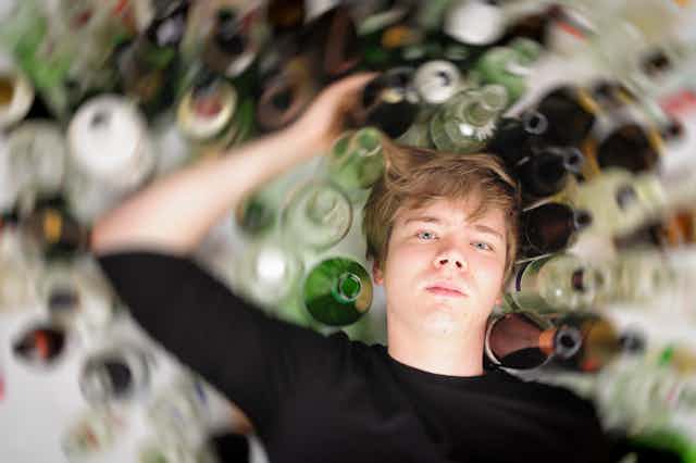 Man with glass bottles of alcohol