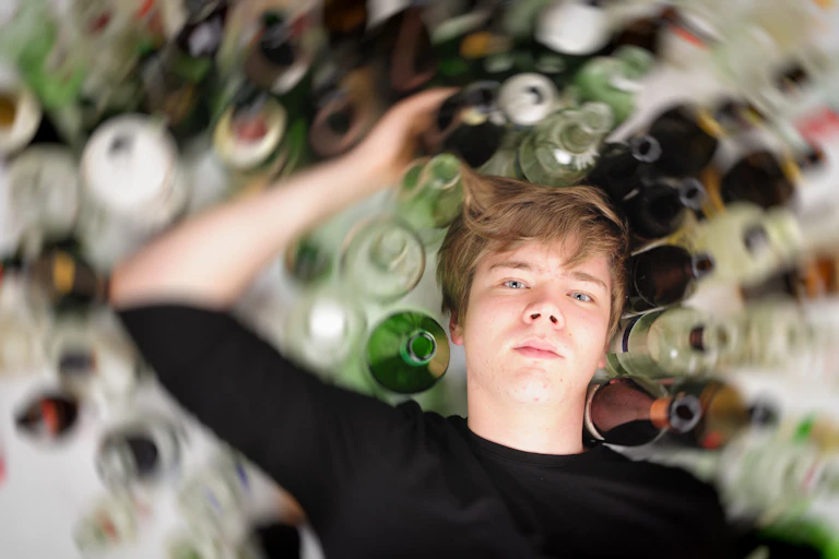 Man with glass bottles of alcohol