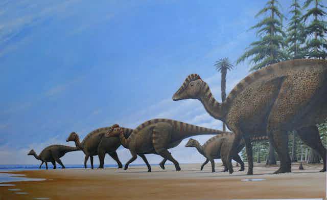 Manada de dinosaurios en la playa