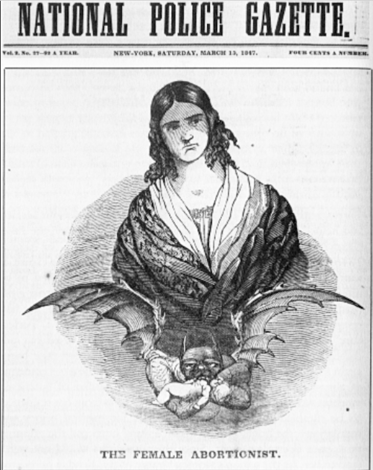 An antique magazine cover with a woman's image on it, holding a baby.