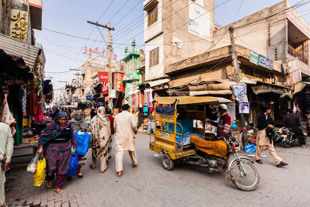 Men and women in a Pakistan street.