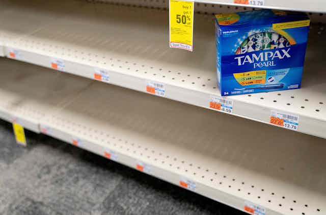Grocery shop shelves are empy save for one box of Tampax
