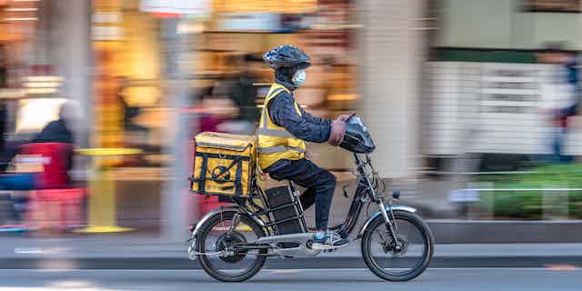 Food delivery rider with electric bicycle.