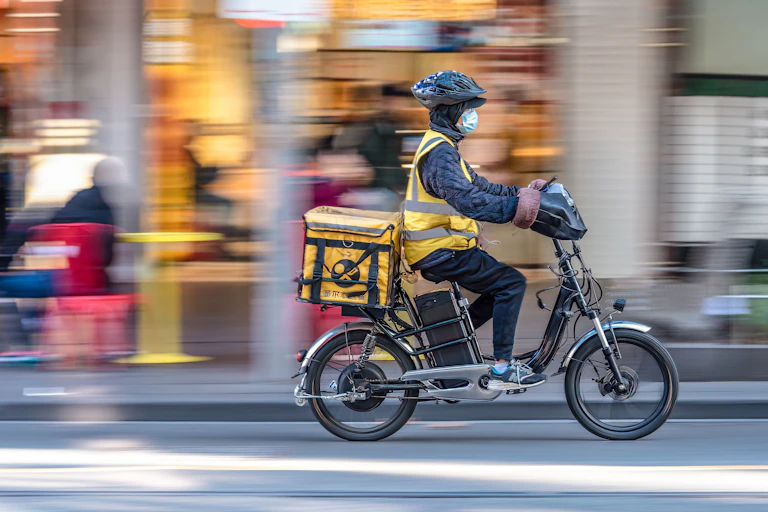 Food delivery rider with electric bicycle.