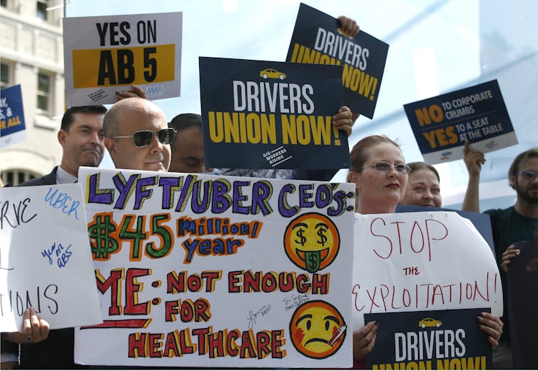 Workers rally in August 2019 in support of California's proposed AB5 law to stop companies categorise workers as independent contractors. The law was passed, but Uber and other platform companies bankrolled a successful attempt in 2020 to be exempt from t