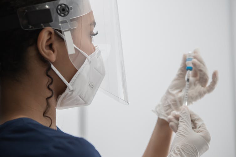 Nurse prepares COVID vaccine