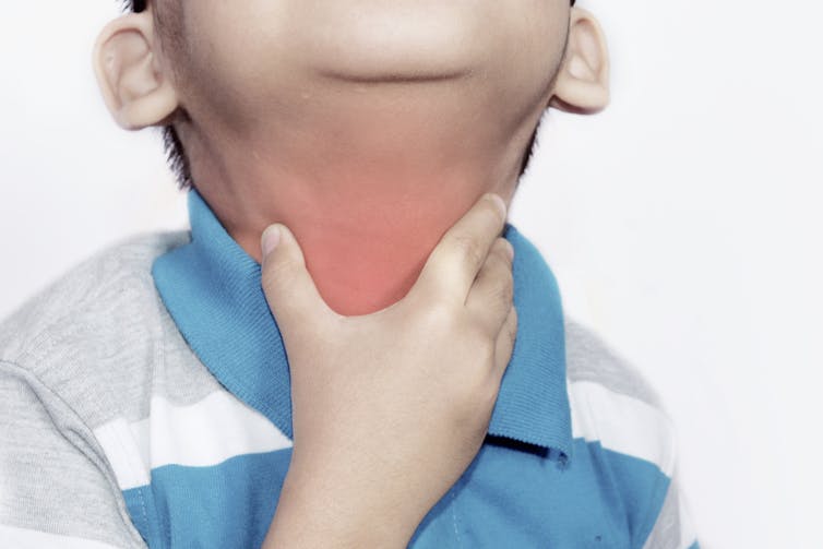 Child touches their sore neck