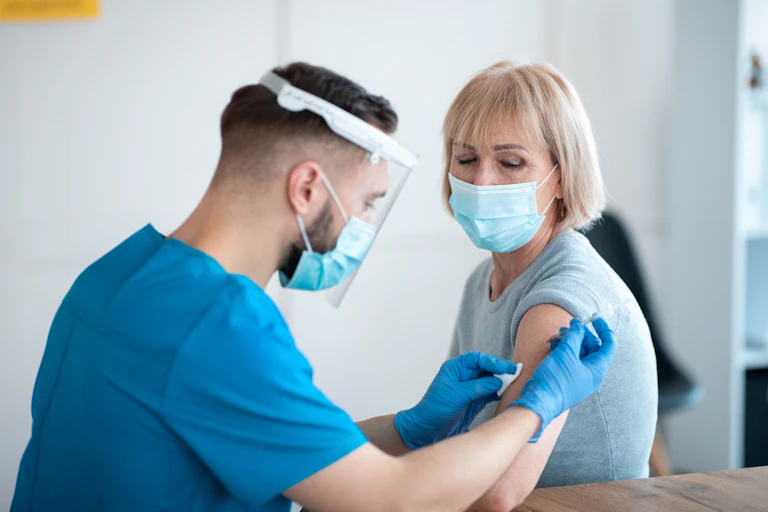A woman receives a vaccination.