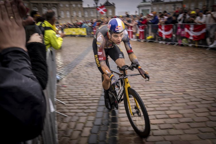 Man riding bike through crowd