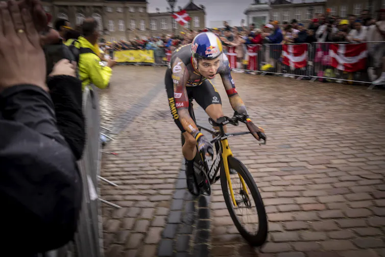 Man riding bike through crowd