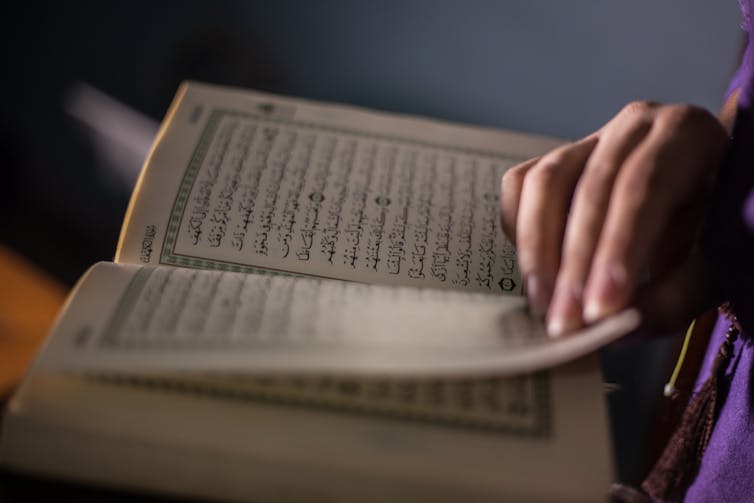 A Muslim woman reads the Quran.