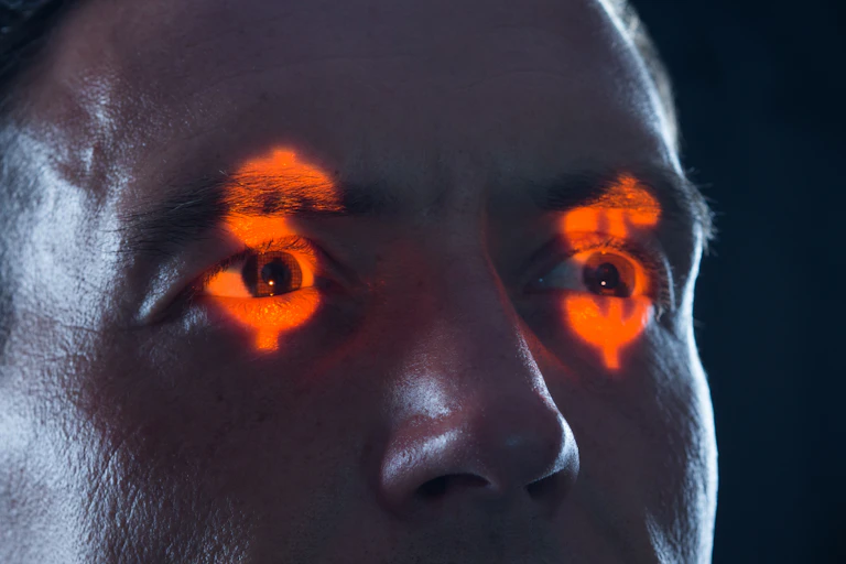 face with dollar symbols reflecting on eyes