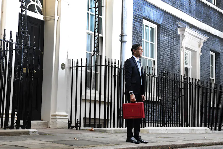 Rishi Sunak stands outside 11 Downing Street, London