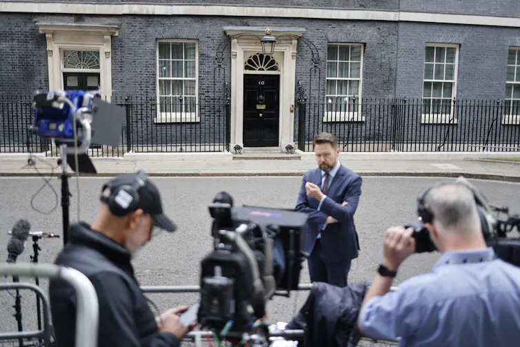 Journalists waiting in front of Downing Street.