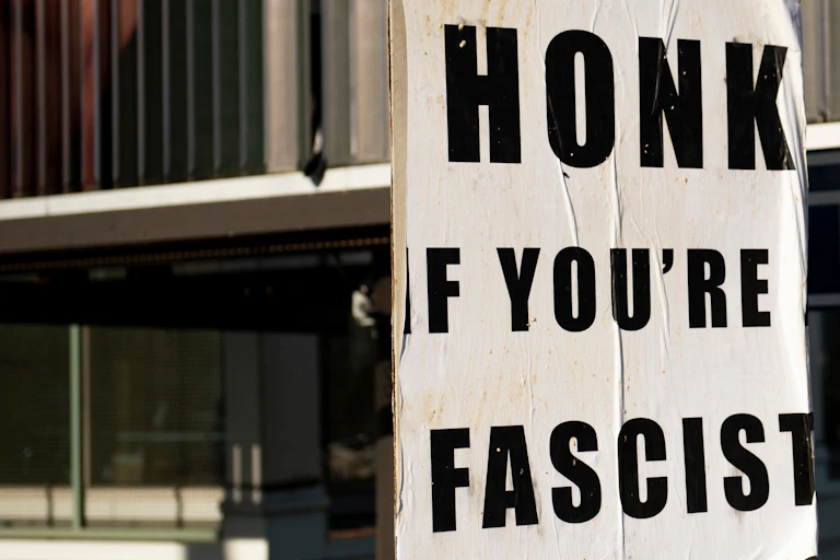 A poster that says "Honk if you're fascist"