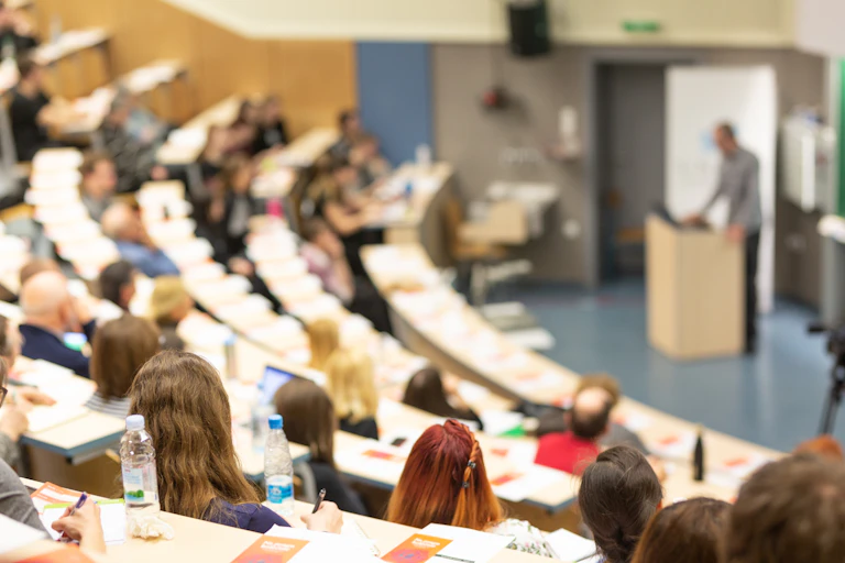 Lecturer addressing hall full of students