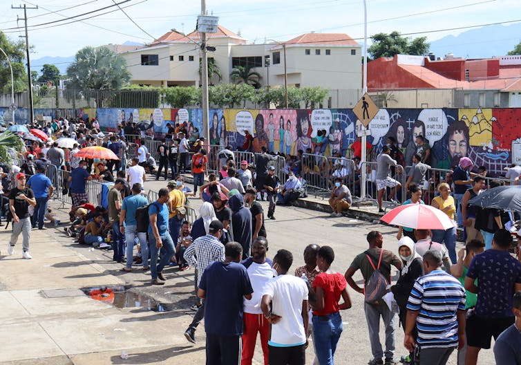 Migrants line up in front of the headquarters of the National Institute of Migration (INM) in the city of Tapachula, state of Chiapas, Mexico, 05 July 2022.