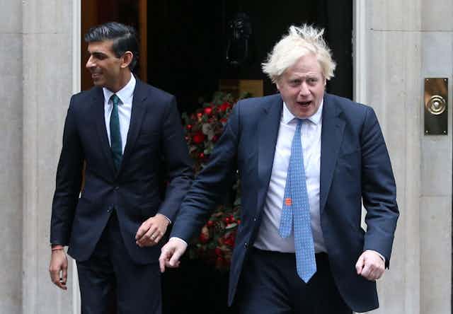 Rishi Sunak and Boris Johnson walking briskly out of Downing Street.