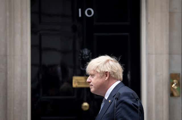 Boris Johnson standing in front of Downing Street.
