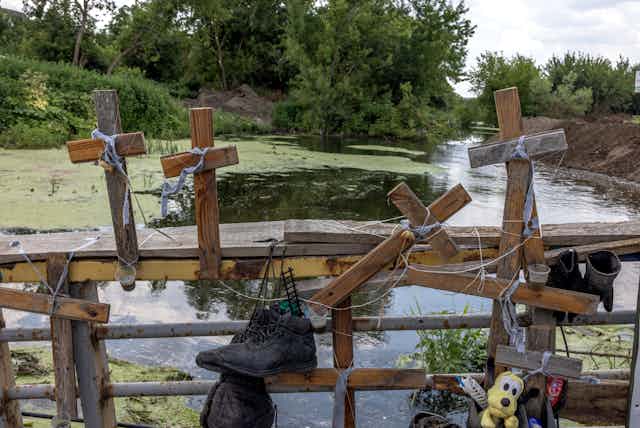Artwork 'Bucha massacre' with the crosses installed under the destroyed bridge in memory of people who were exhumed in Bucha after the retreat of the Russian army, in Irpin, Ukraine