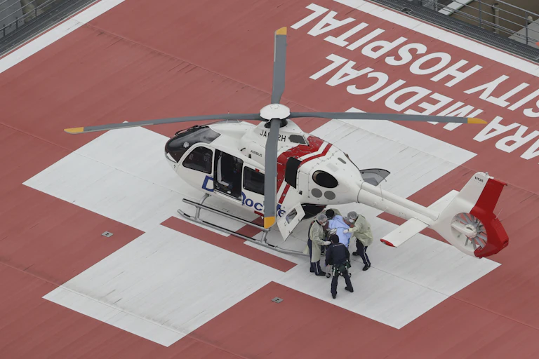 Person on gurney being put into helicopter.