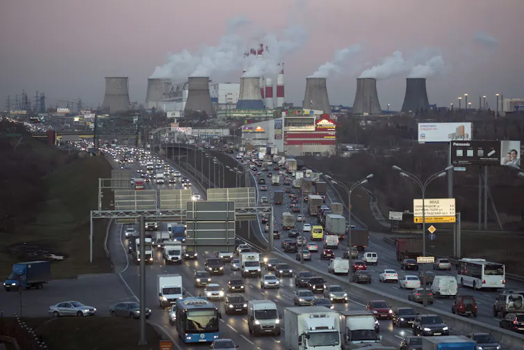 urban scene with cars and coal stacks