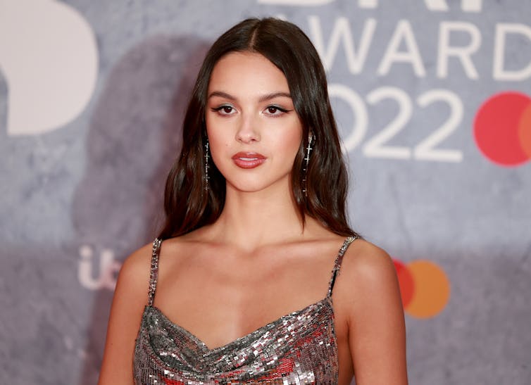 A woman poses on the red carpet