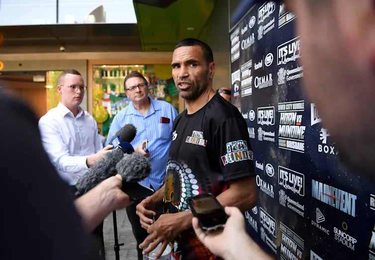 Aboriginal boxer Anthony Mundine being interviewed by non-Indigenous reporters.