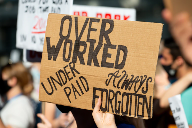 A placard held aloft by a protestor.