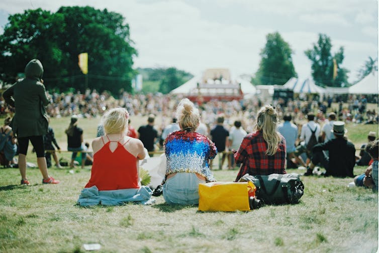 Friends sit on the grass