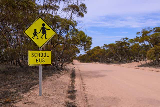 School bus sign on a dirt road in the country