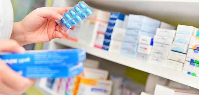 Pharmacist holds up medicine